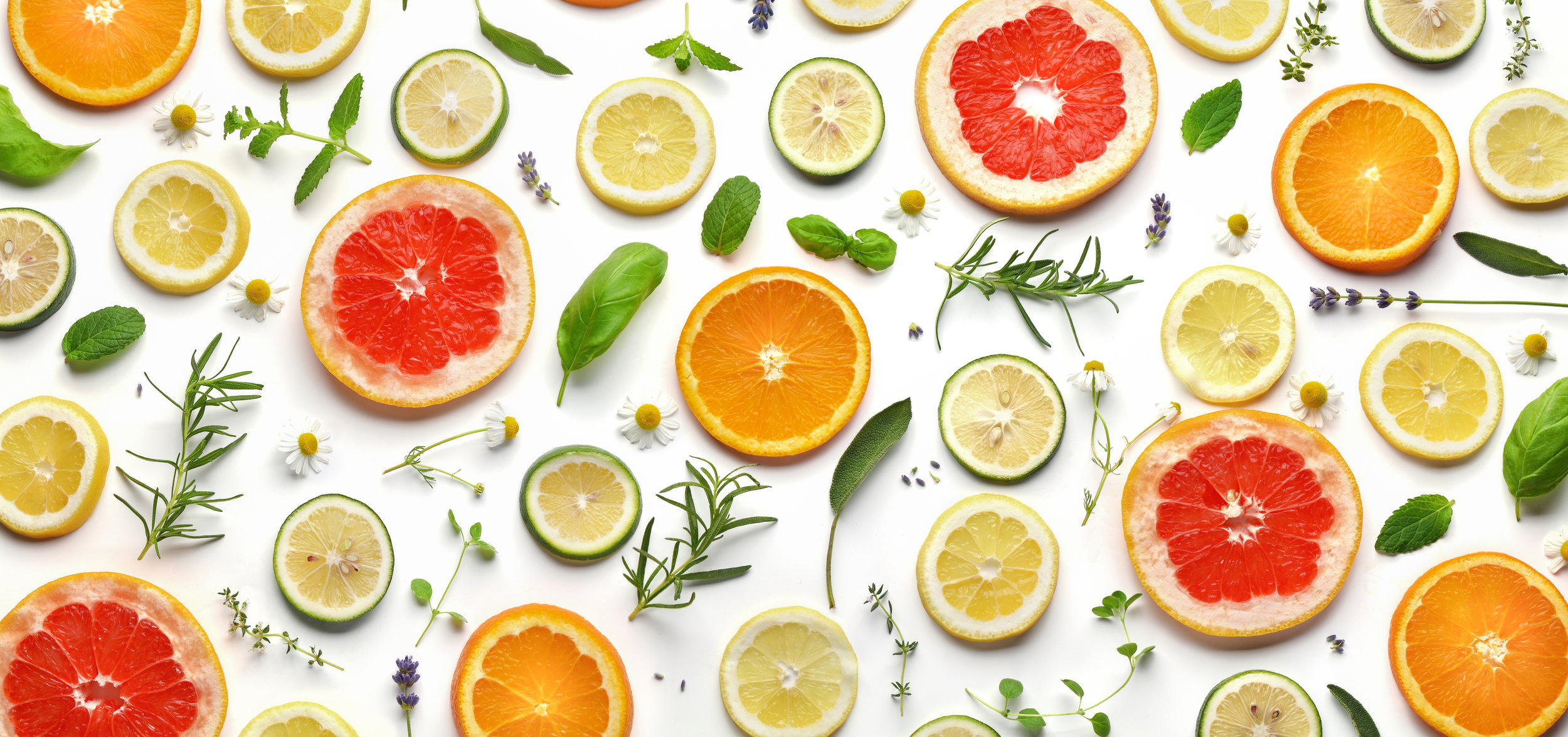 Sliced fruits and herbs on white